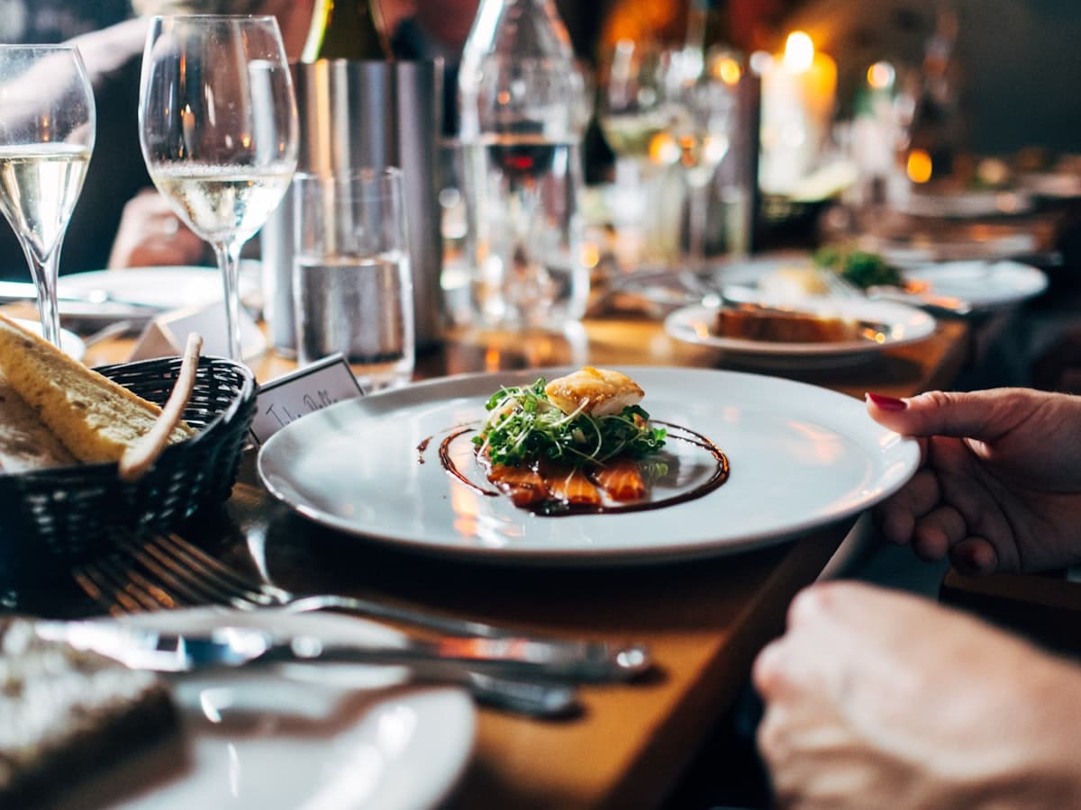 A table set for service at Marrow — small plates and a glass of red