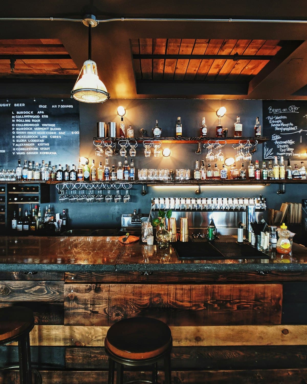The back bar at Marrow — bottles lined along the counter under low light